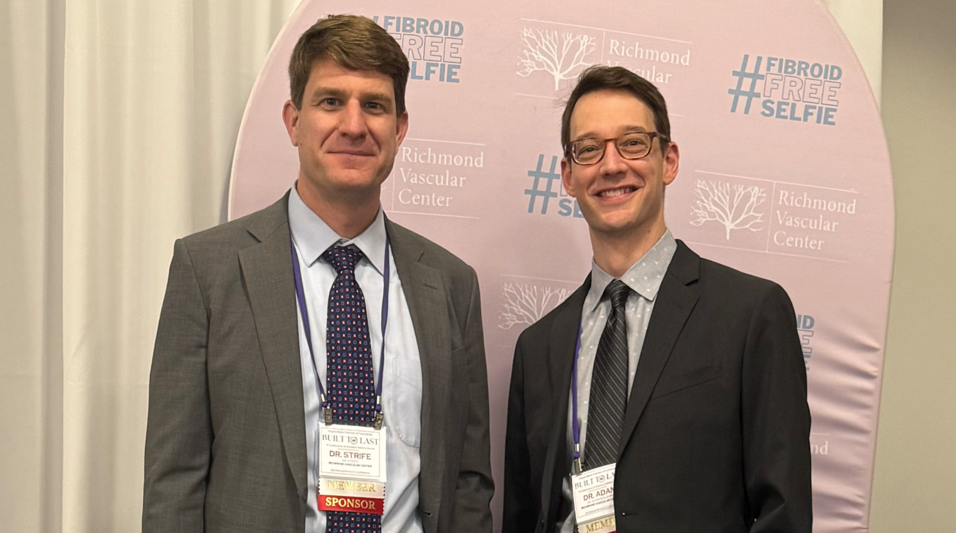 two men smiling at the camera